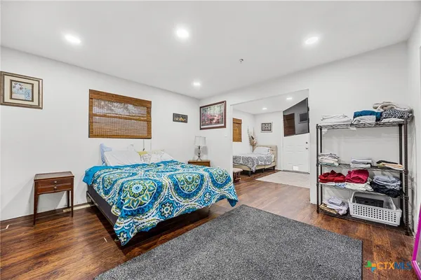 a spacious bedroom with a bed and a walk in closet