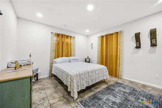 a bedroom with a bed and a dresser