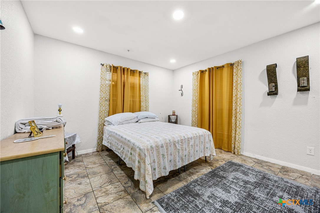 15309 Delahunty Lane Pflugerville, TX 78660 - Photo 20 of 35 a bedroom with a bed and a dresser