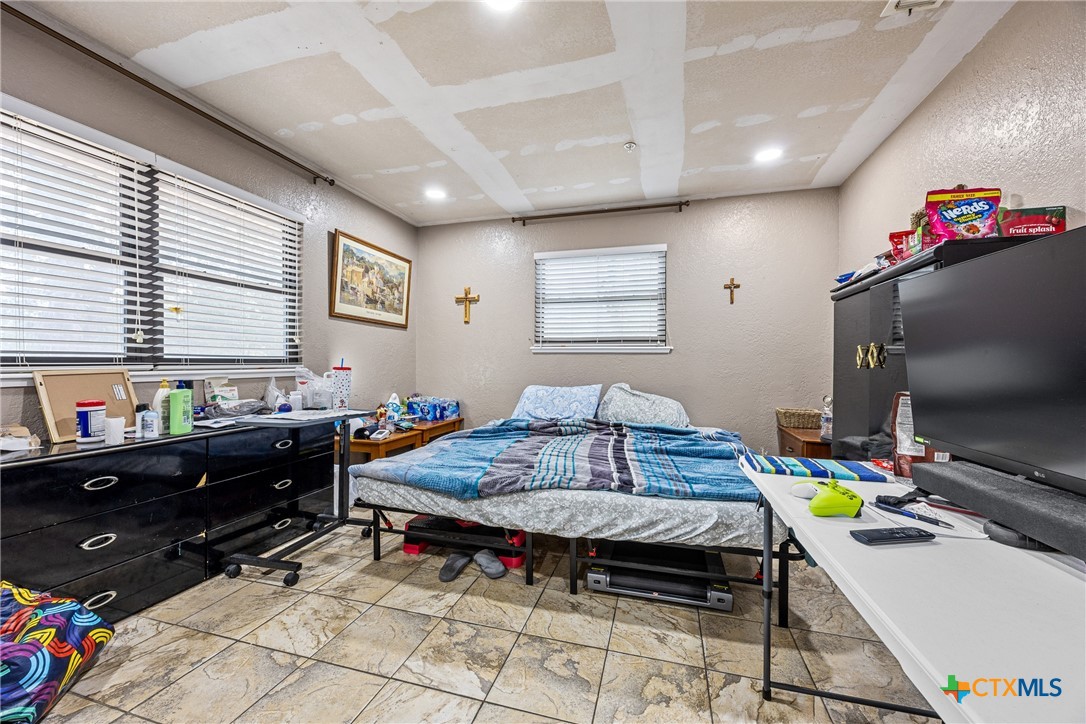 15309 Delahunty Lane Pflugerville, TX 78660 - Photo 24 of 35 a bedroom with a bed and a flat screen tv