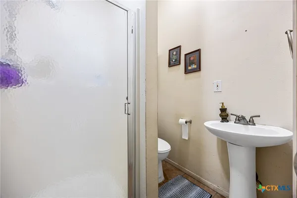 a bathroom with a sink mirror and toilet