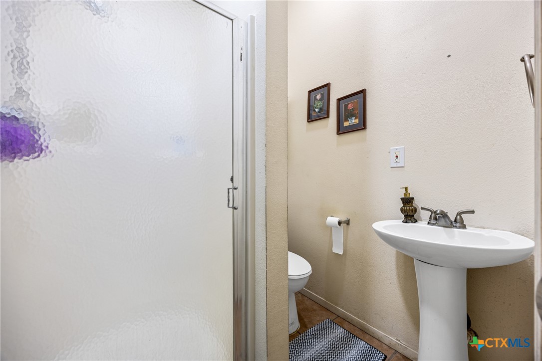 15309 Delahunty Lane Pflugerville, TX 78660 - Photo 28 of 35 a bathroom with a sink mirror and toilet