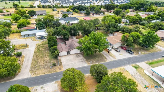 an aerial view of residential houses with outdoor space