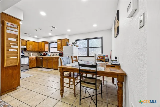 a kitchen with stainless steel appliances kitchen island granite countertop a sink and cabinets