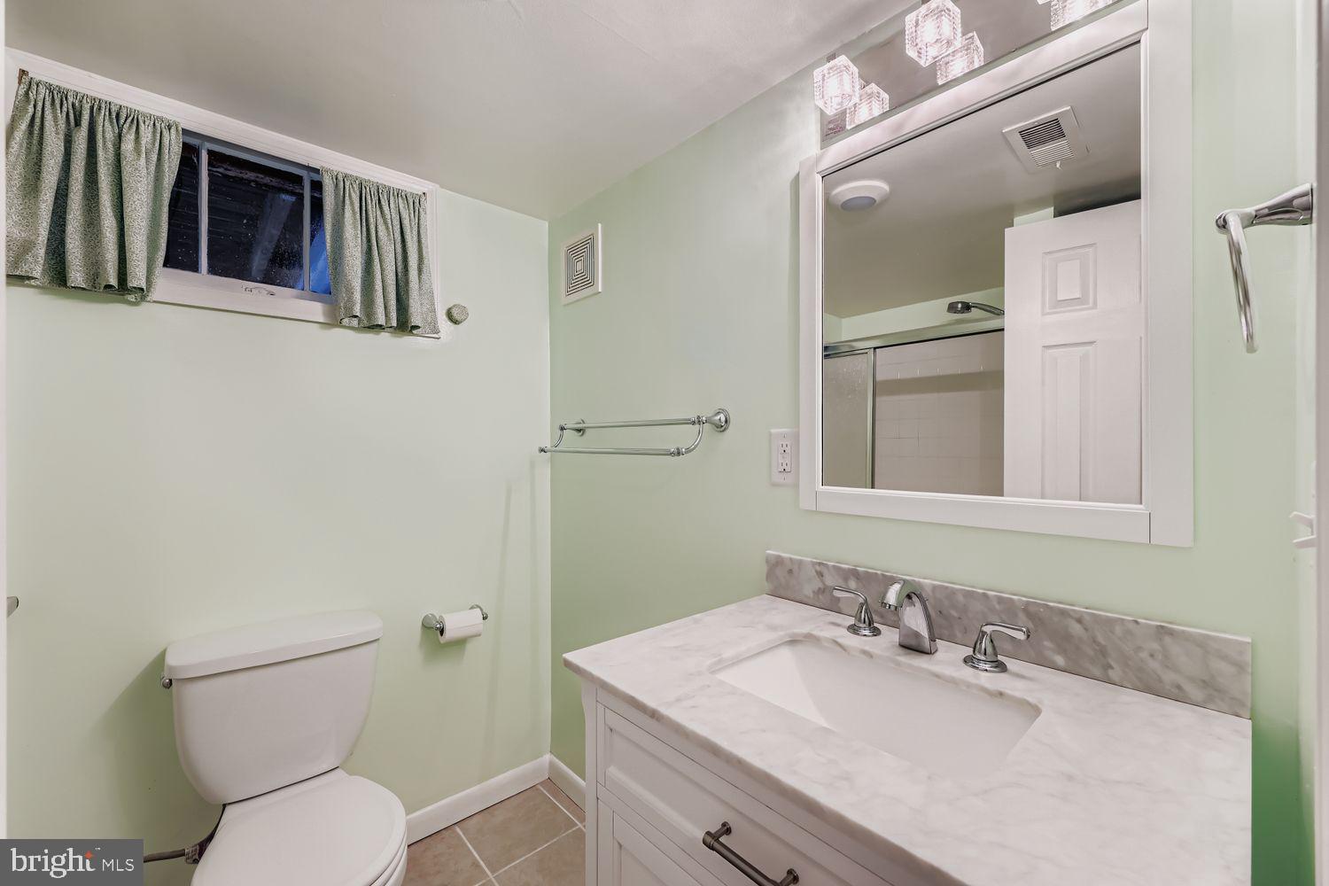 8119 Kirkwall Court Towson, MD 21286 - Photo 28 of 39 a bathroom with a granite countertop toilet sink and mirror