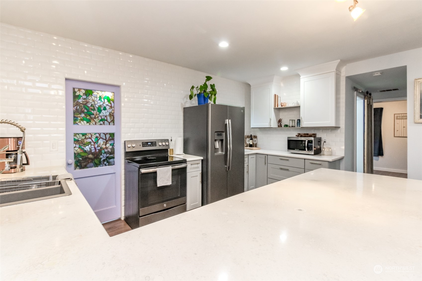 3903 Freeman Road East Edgewood, WA 98371 - Photo 11 of 40 a kitchen with granite countertop a refrigerator stove and oven