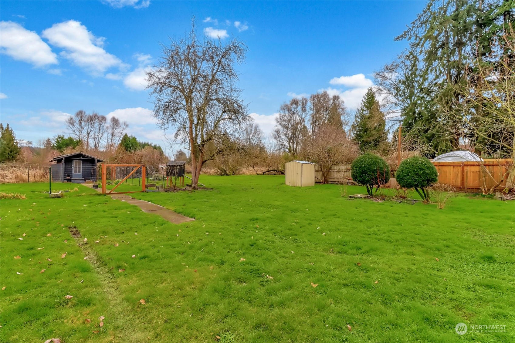 3903 Freeman Road East Edgewood, WA 98371 - Photo 35 of 40 a view of a garden with a building in the background