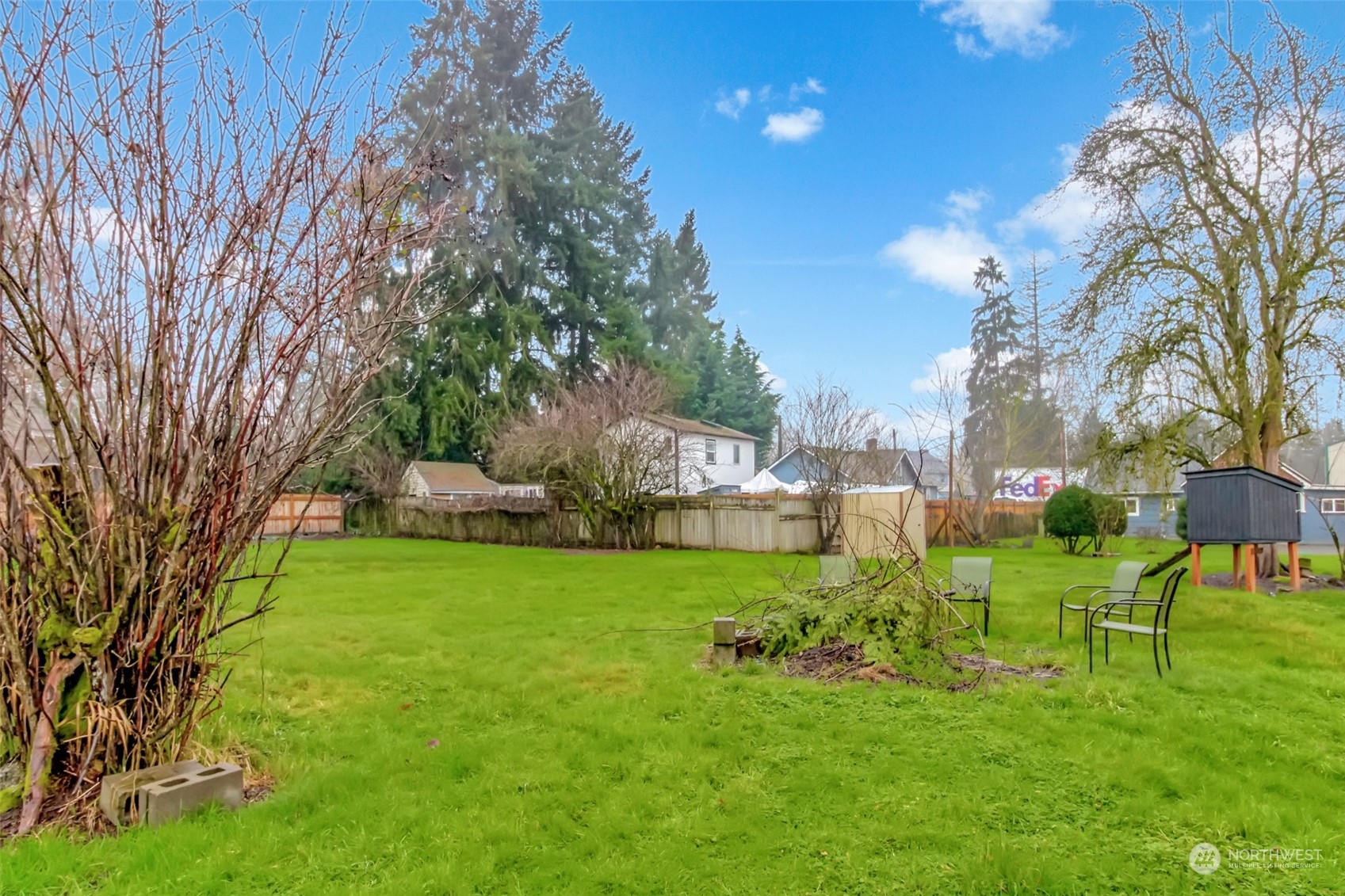 3903 Freeman Road East Edgewood, WA 98371 - Photo 38 of 40 a view of backyard with table and chairs and a large tree