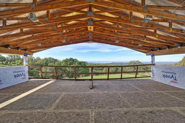 a view of a large building with mountains in the background