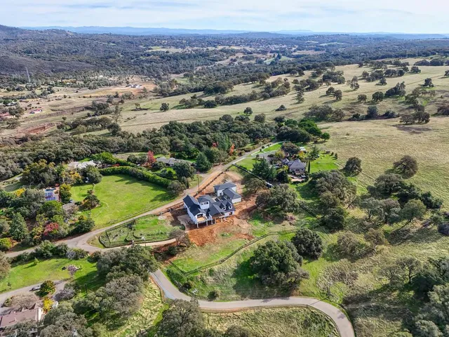 an aerial view of residential house and sandy dunes