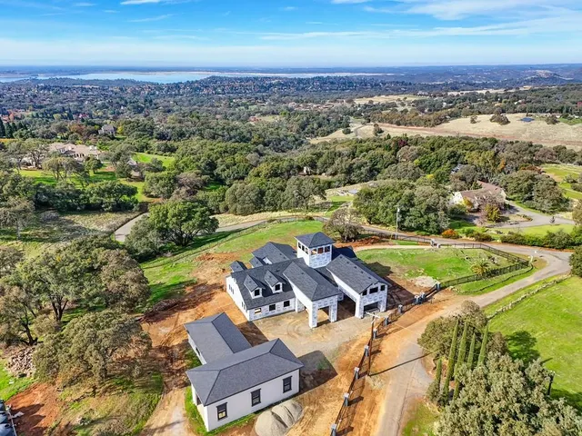 an aerial view of a house with a swimming pool