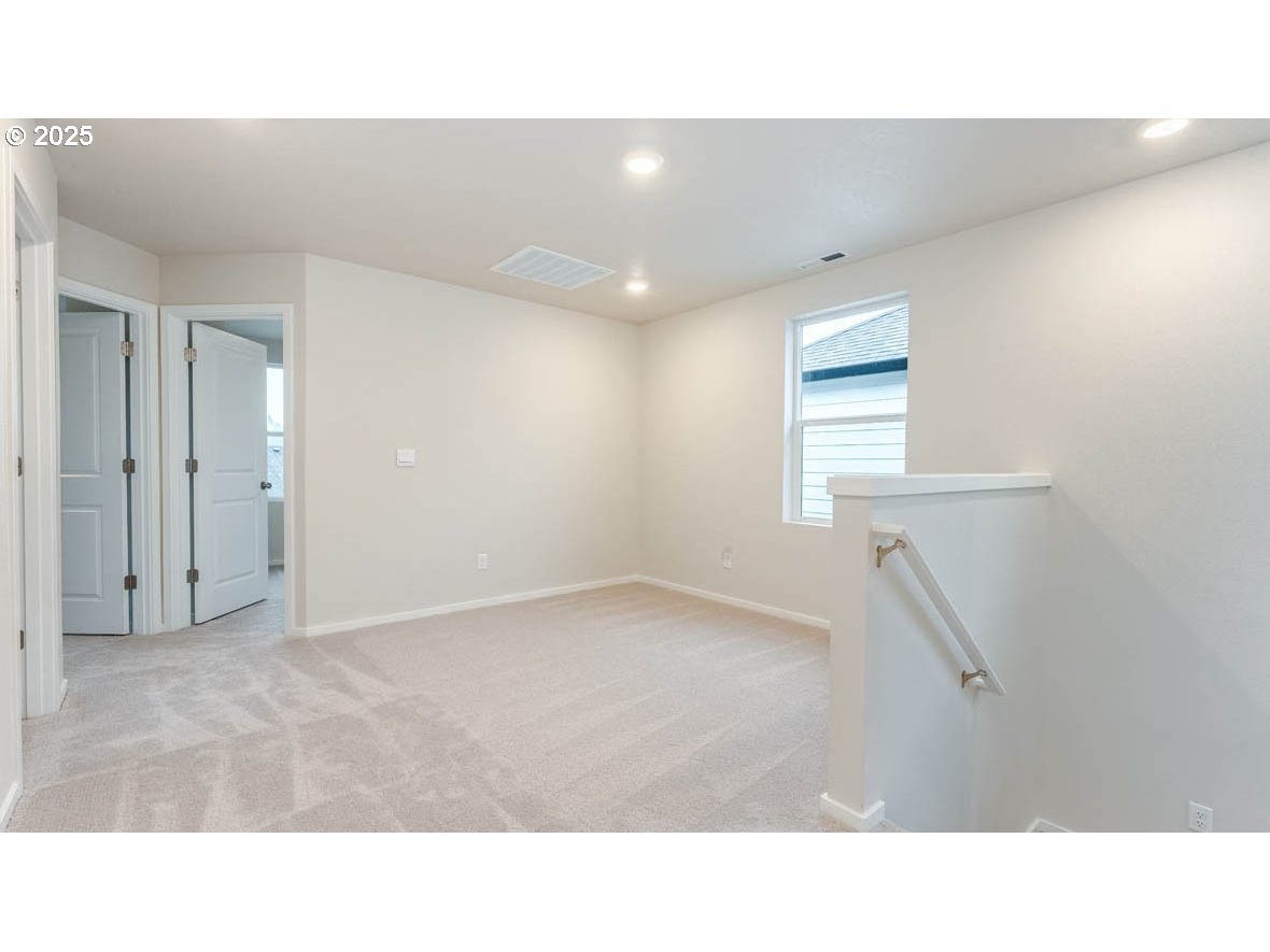 2975 T Street Springfield, OR 97477 - Photo 11 of 28 a open hall with a ceiling fan