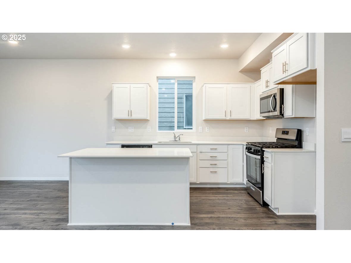 2975 T Street Springfield, OR 97477 - Photo 6 of 28 a kitchen with a sink cabinets and a window