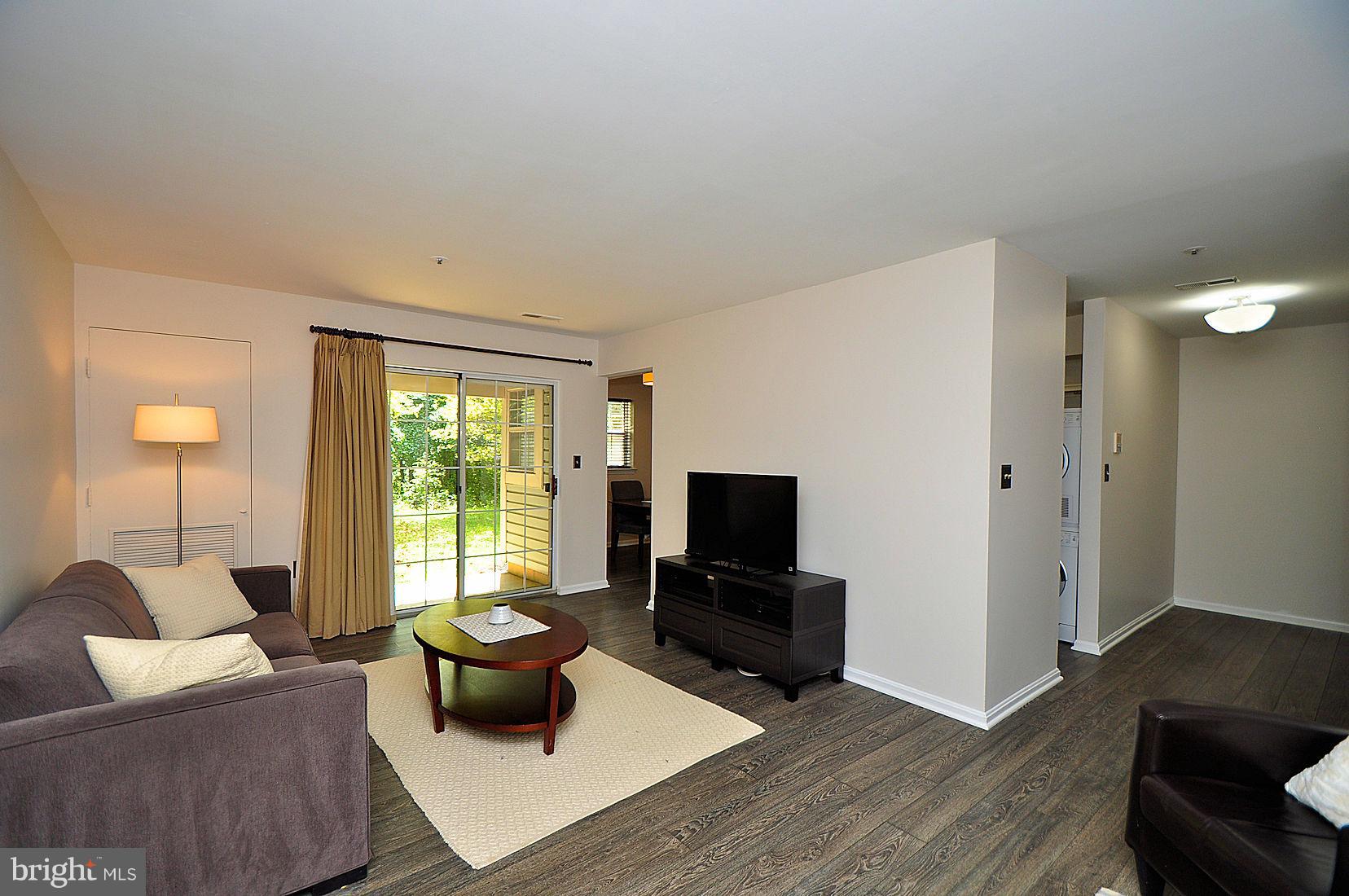 8399 Montgomery Run Road, Unit B Ellicott City, MD 21043 - Photo 3 of 22 Living Room with slider door to patio