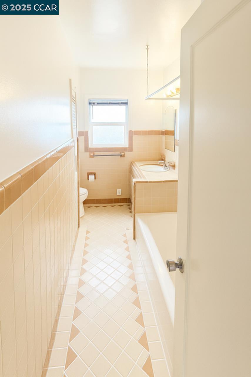 211 Second Street, Unit TOP Rodeo, CA 94572 - Photo 11 of 12 a bathroom with a tub and a shower