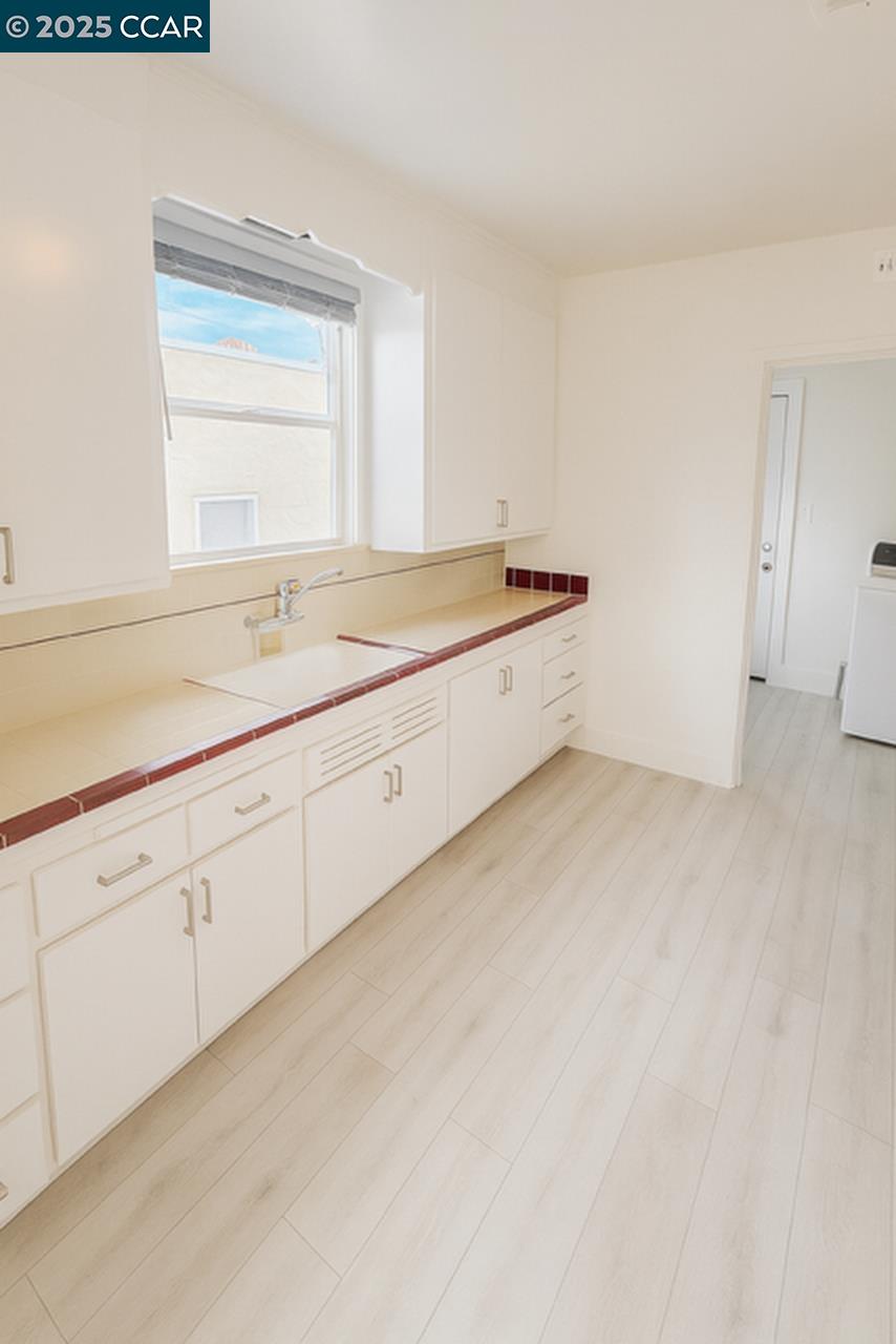 211 Second Street, Unit TOP Rodeo, CA 94572 - Photo 5 of 12 a large white kitchen with a sink