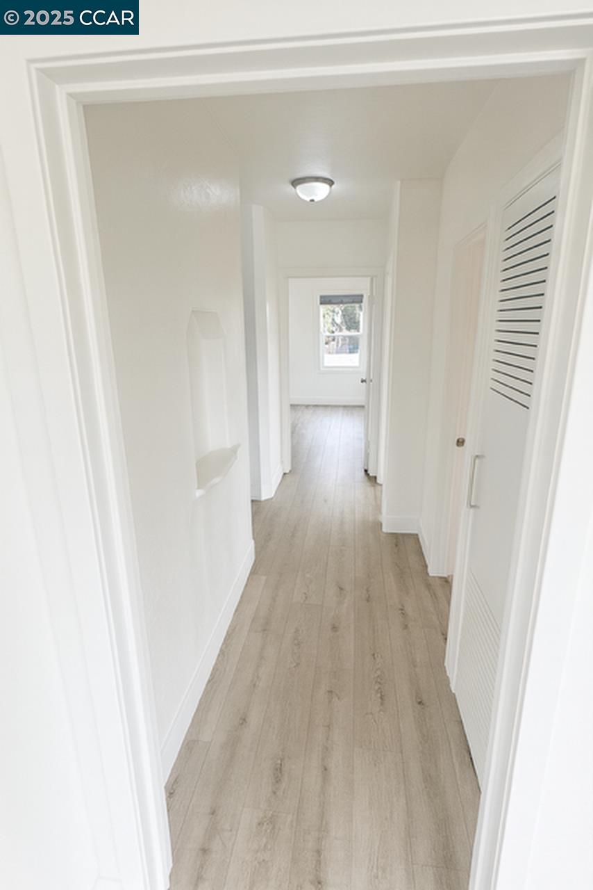 211 Second Street, Unit TOP Rodeo, CA 94572 - Photo 8 of 12 a view of a hallway with wooden floor and closet
