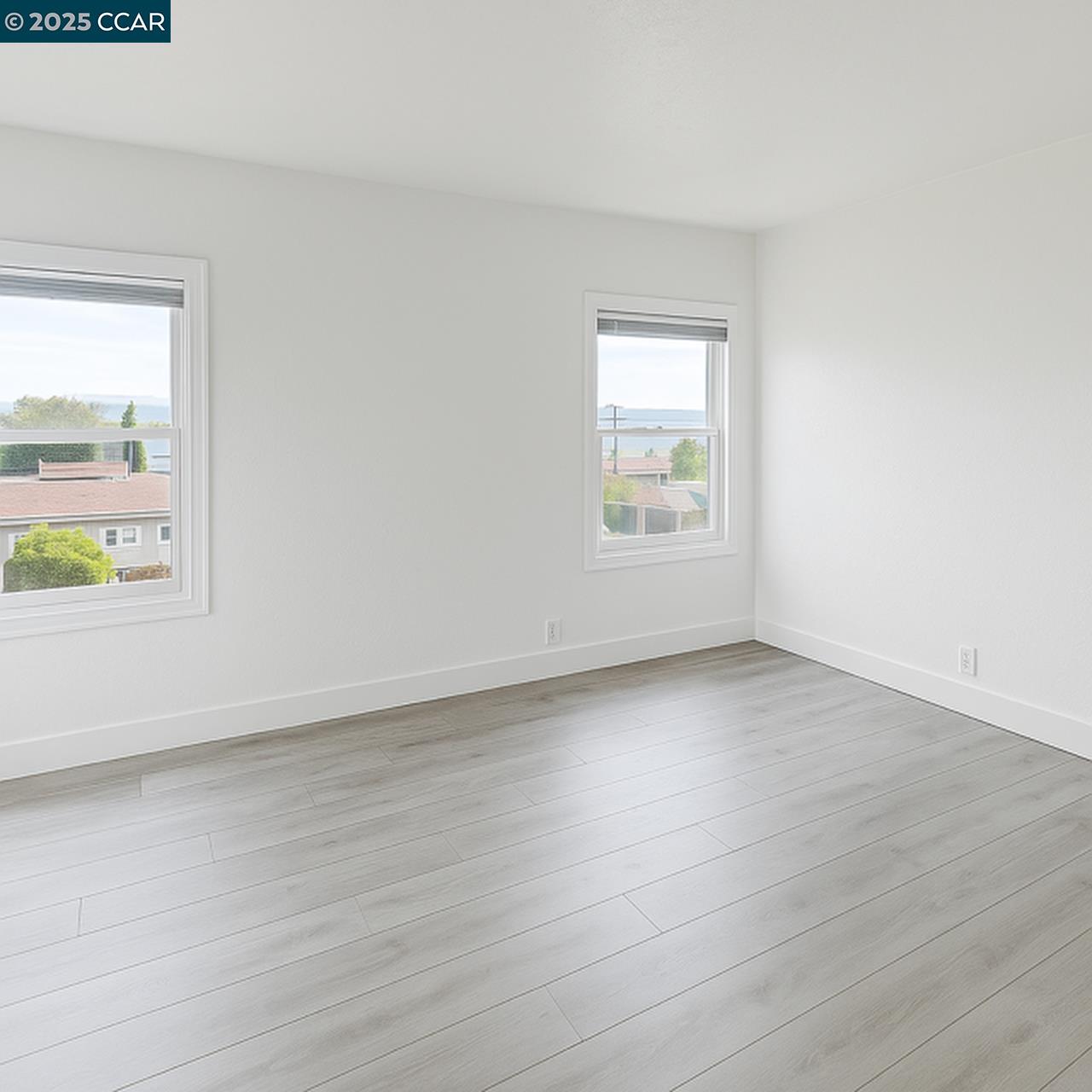 211 Second Street, Unit TOP Rodeo, CA 94572 - Photo 10 of 12 an empty room with wooden floor and windows