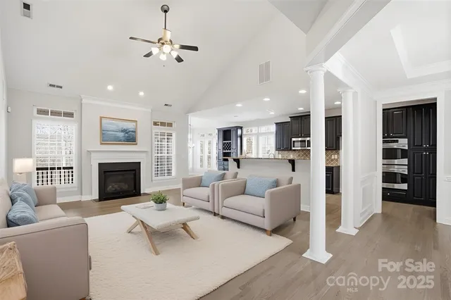 a living room with furniture fireplace and window