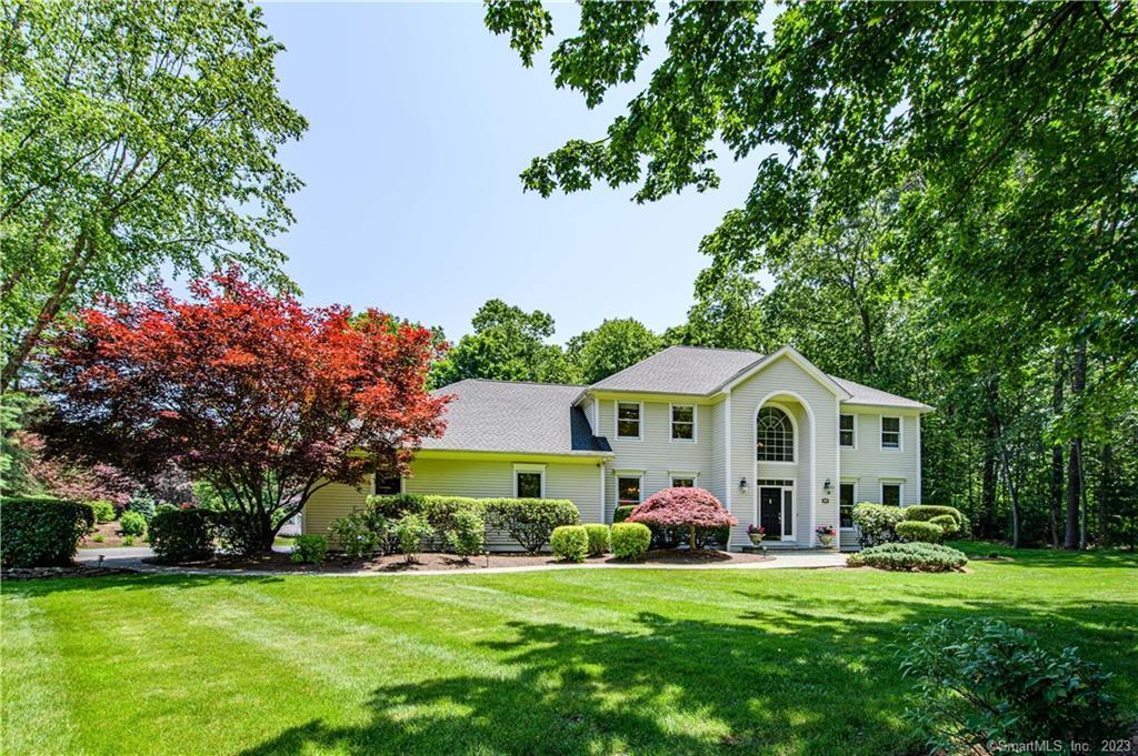 310 Oregon Road Cheshire, CT 06410 - Photo 1 of 1 a front view of a house with a garden and trees