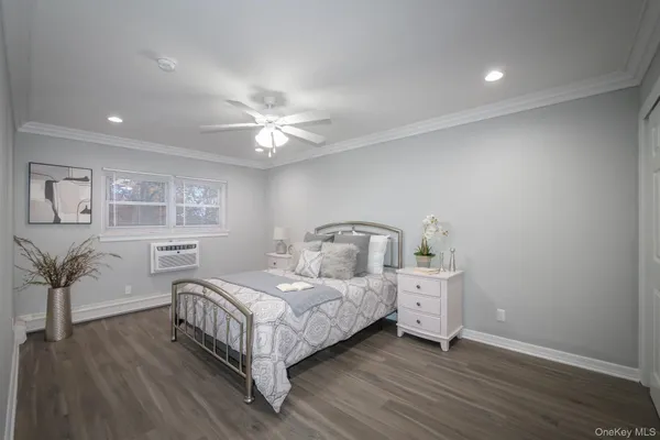 a room with a bed and a table with wooden floor