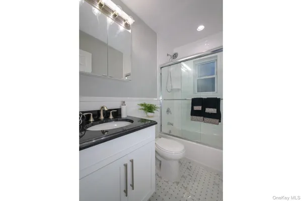 a bathroom with a sink double vanity and a mirror