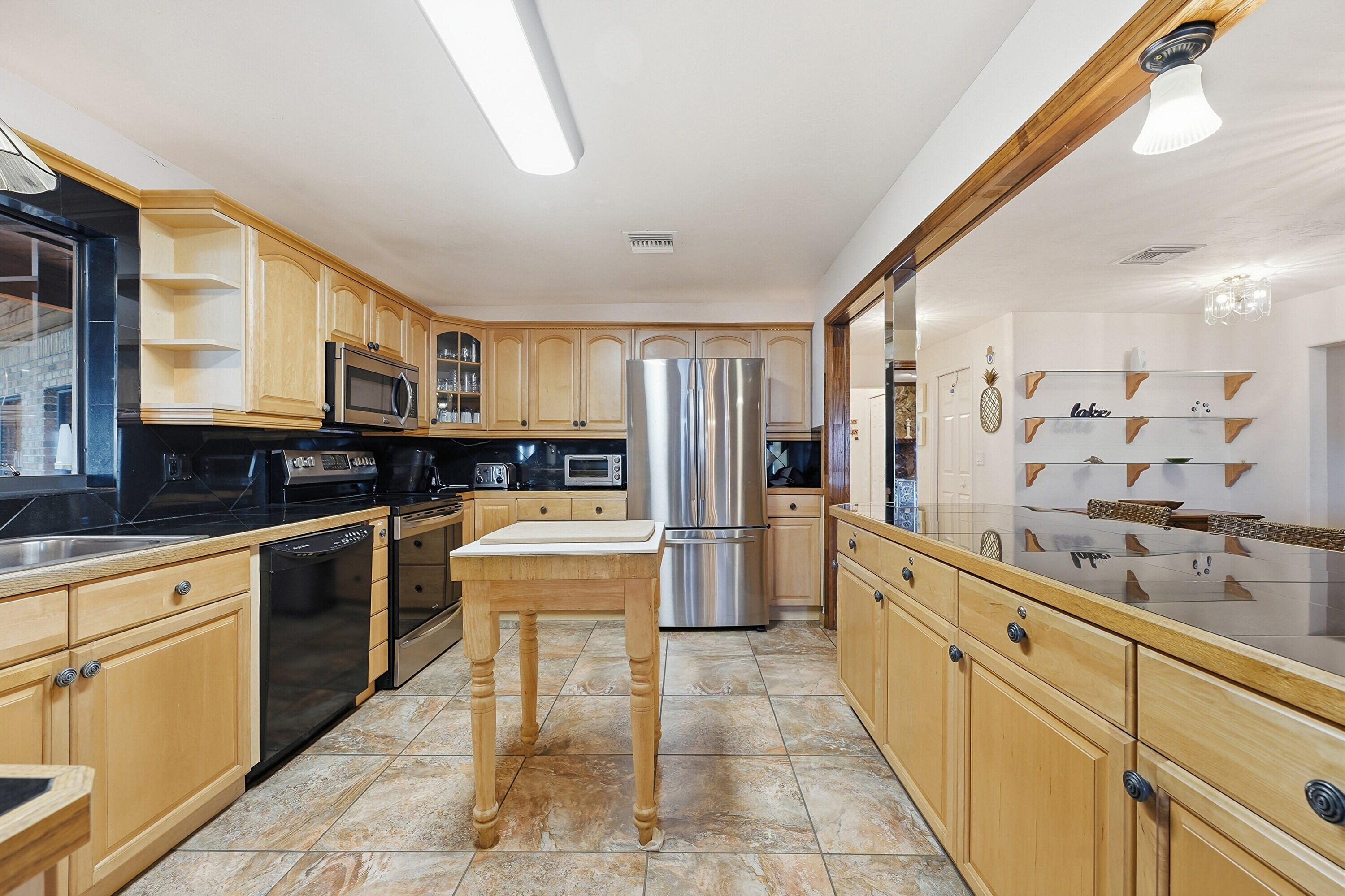 200 Windy Point Road Lake Placid, FL 33852 - Photo 6 of 74 a large kitchen with stainless steel appliances lots of counter space and windows