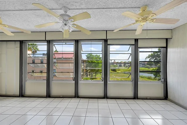 a view of a livingroom with a ceiling fan and window