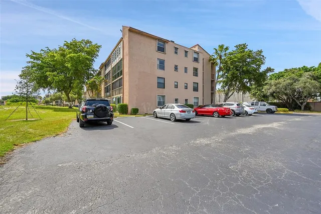 a car parked in front of a building with trees
