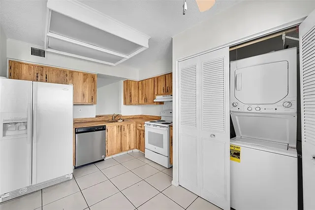 a kitchen with stainless steel appliances granite countertop a refrigerator and a stove