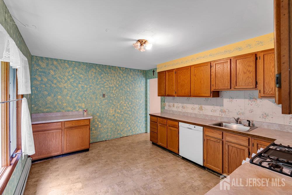 213 East Greystone Road Old Bridge, NJ 08857 - Photo 16 of 32 a kitchen with stainless steel appliances granite countertop a sink stove and refrigerator