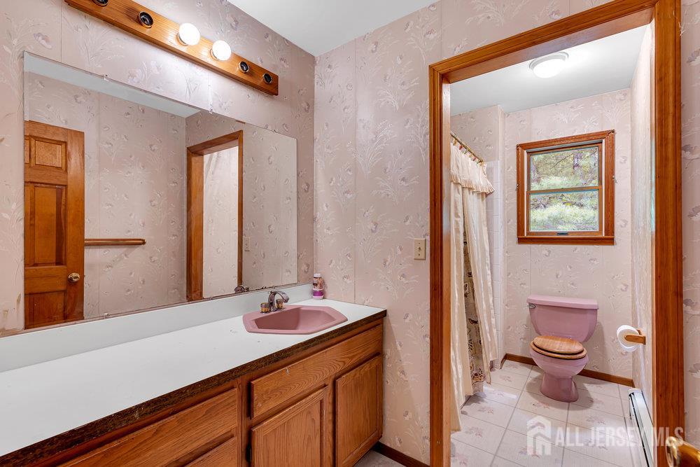 213 East Greystone Road Old Bridge, NJ 08857 - Photo 18 of 32 a bathroom with a sink a toilet and mirror