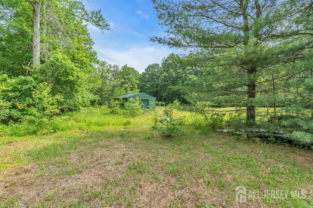 213 East Greystone Road Old Bridge, NJ 08857 - Photo 2 of 32 a big yard with lots of green space and house in the back