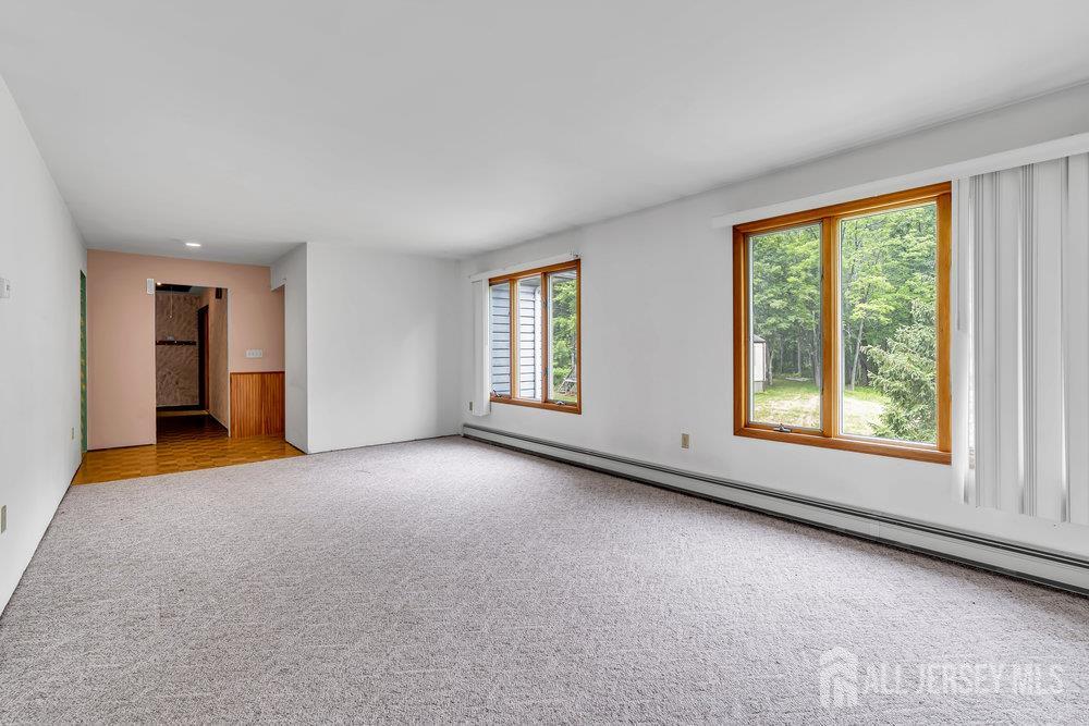 213 East Greystone Road Old Bridge, NJ 08857 - Photo 9 of 32 an empty room with windows