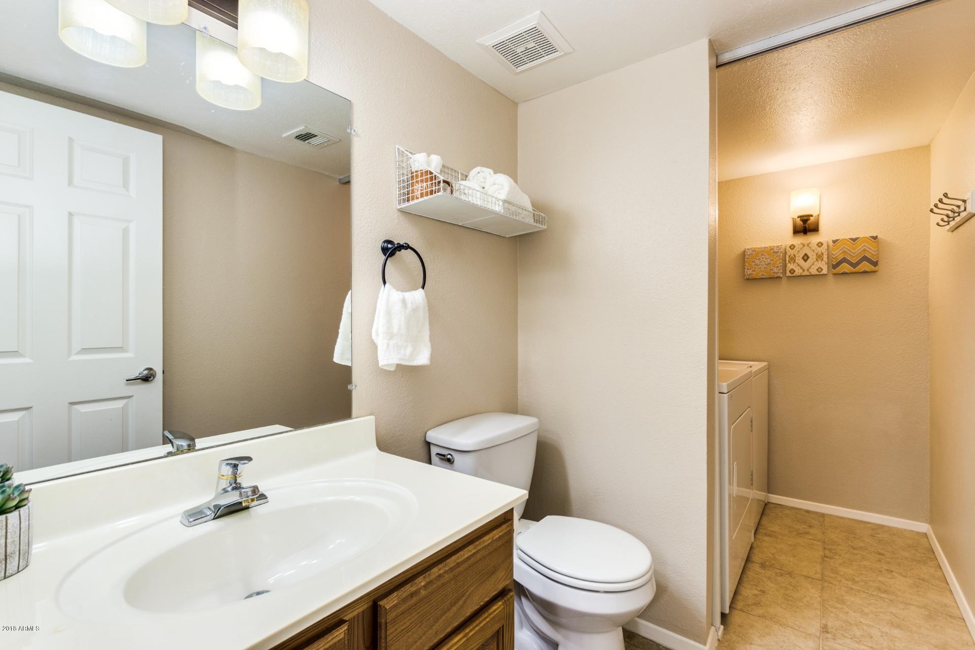 3511 East Baseline Road, Unit 1082 Phoenix, AZ 85042 - Photo 11 of 23 a bathroom with a sink a toilet and a mirror