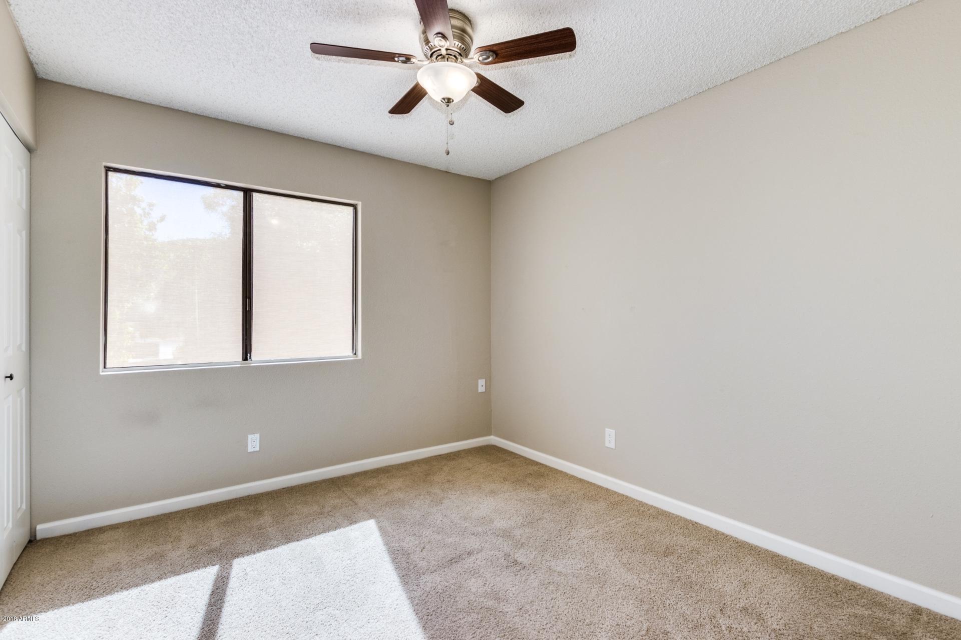 3511 East Baseline Road, Unit 1082 Phoenix, AZ 85042 - Photo 12 of 23 an empty room with a window