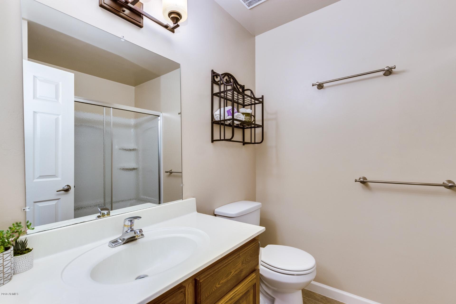 3511 East Baseline Road, Unit 1082 Phoenix, AZ 85042 - Photo 15 of 23 a bathroom with a sink and a mirror