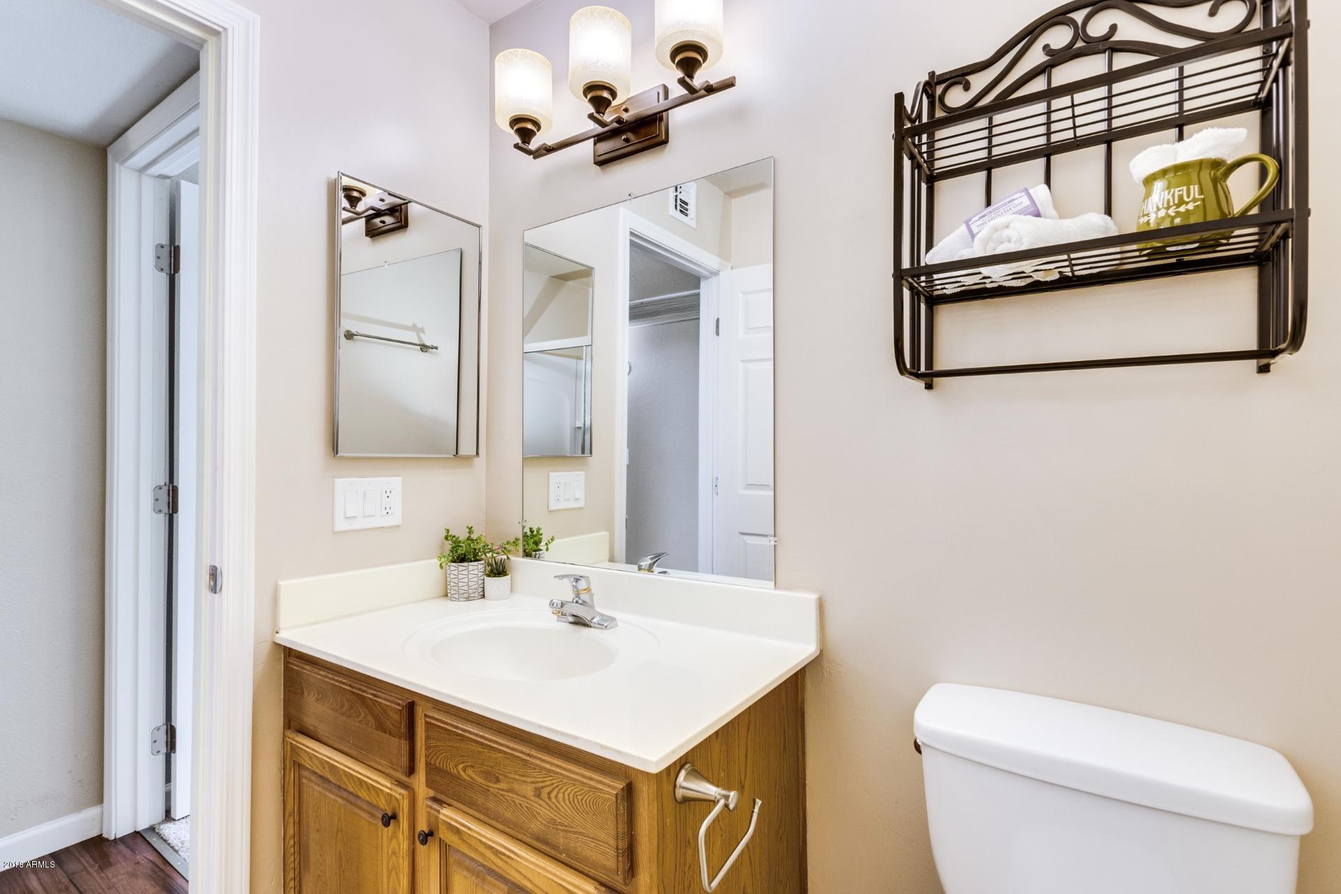 3511 East Baseline Road, Unit 1082 Phoenix, AZ 85042 - Photo 16 of 23 a bathroom with a sink a toilet and mirror