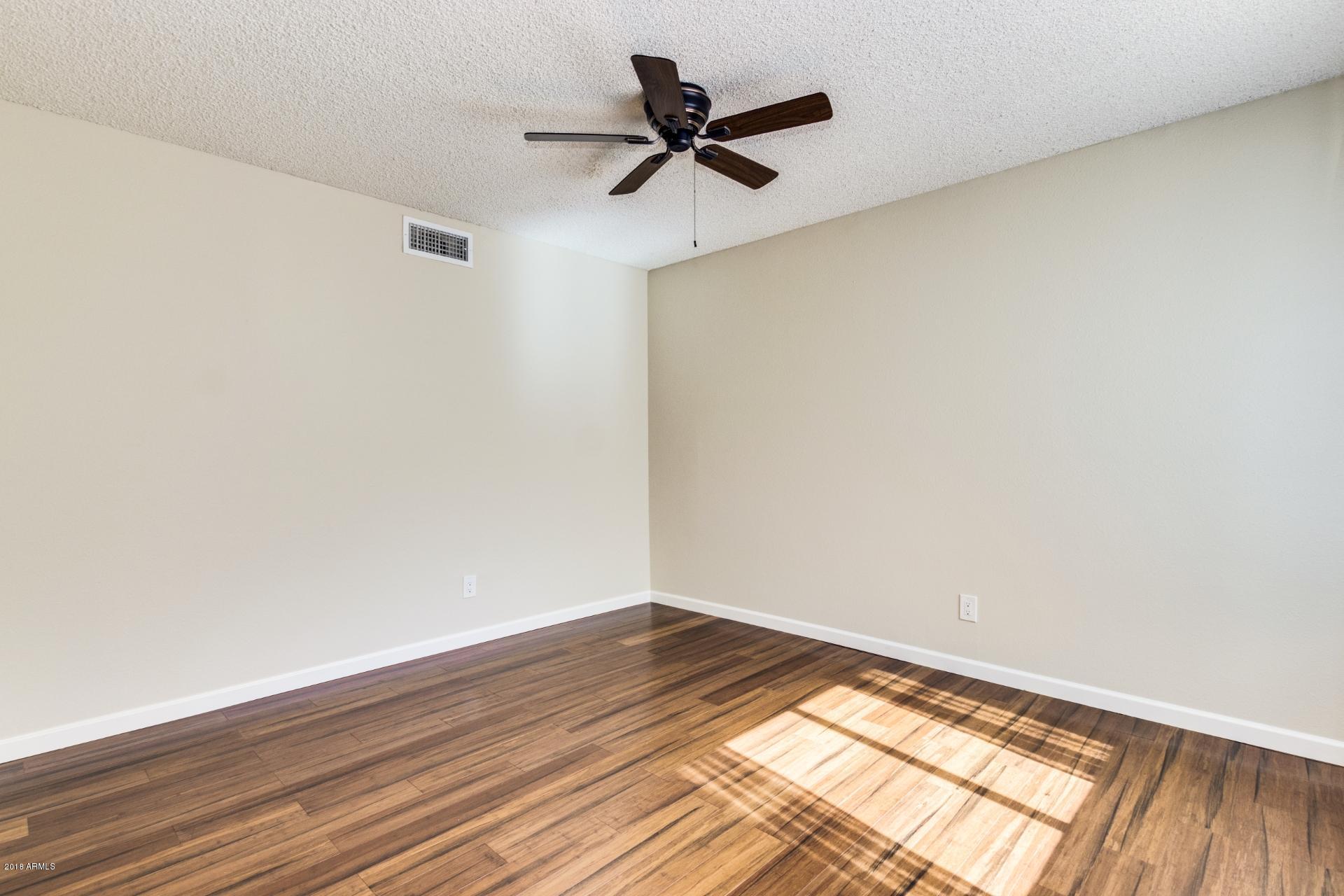 3511 East Baseline Road, Unit 1082 Phoenix, AZ 85042 - Photo 4 of 23 wooden floor in an empty room