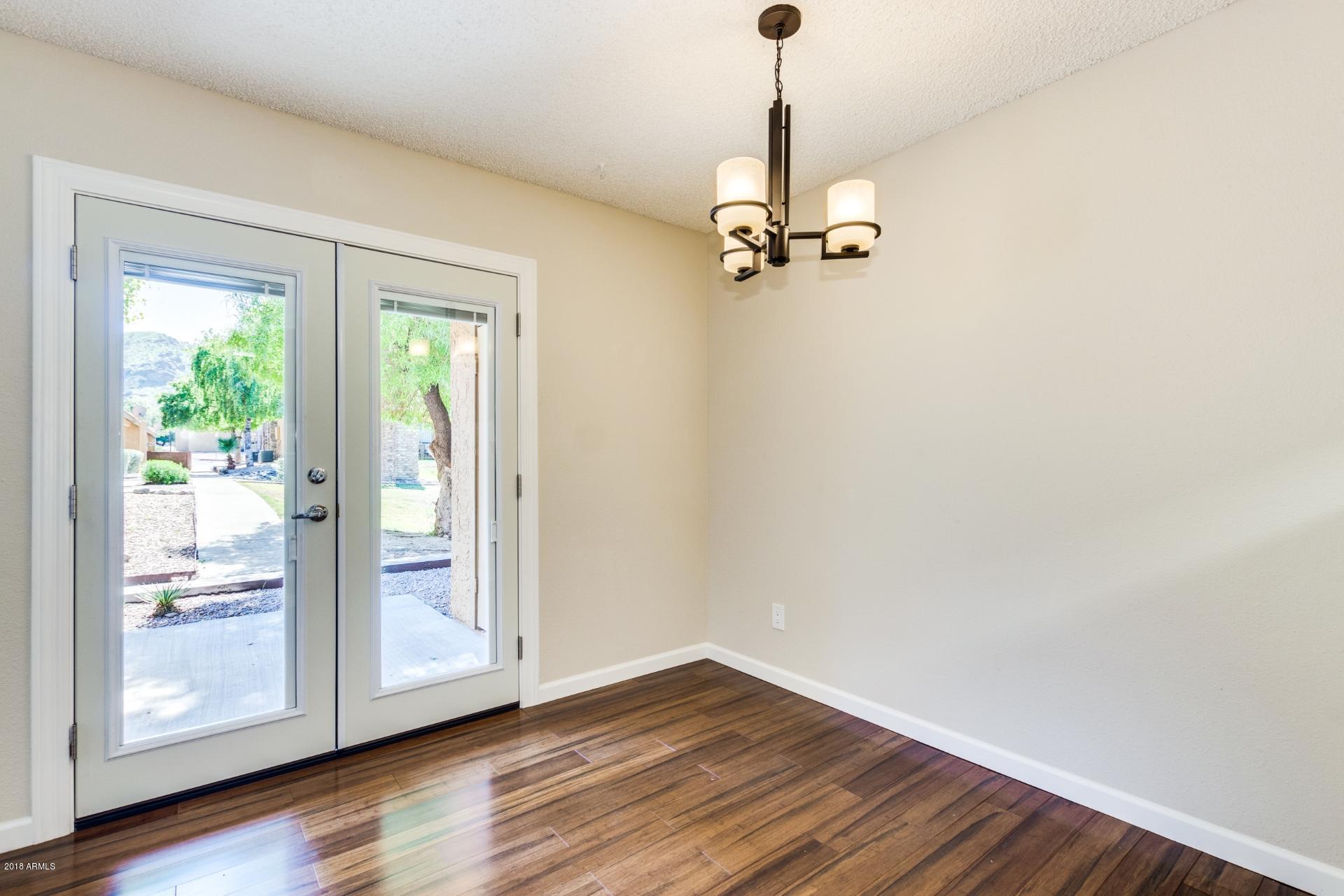 3511 East Baseline Road, Unit 1082 Phoenix, AZ 85042 - Photo 6 of 23 a view of empty room with wooden floor