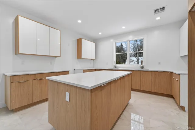 a kitchen with a sink cabinets and window