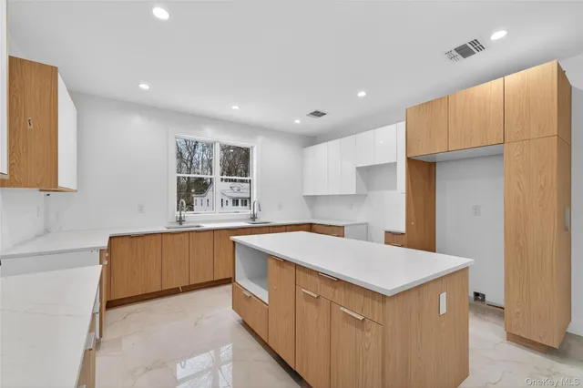 a kitchen that has a sink a stove and a refrigerator