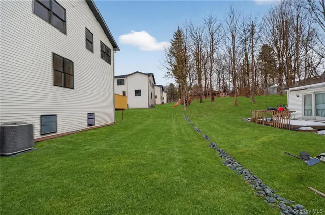 a front view of house with yard and trees