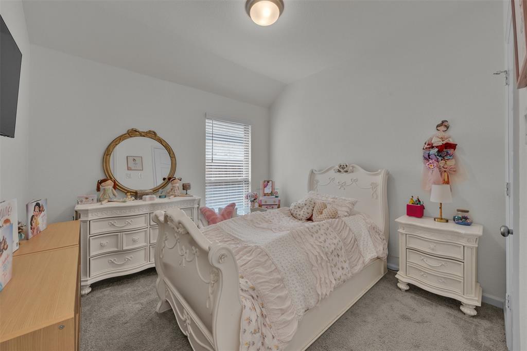 228 Palo Duro Bend Rhome, TX 76078 - Photo 11 of 35 a bedroom with a bed and a chandelier