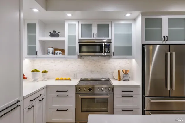a kitchen with refrigerator and cabinets