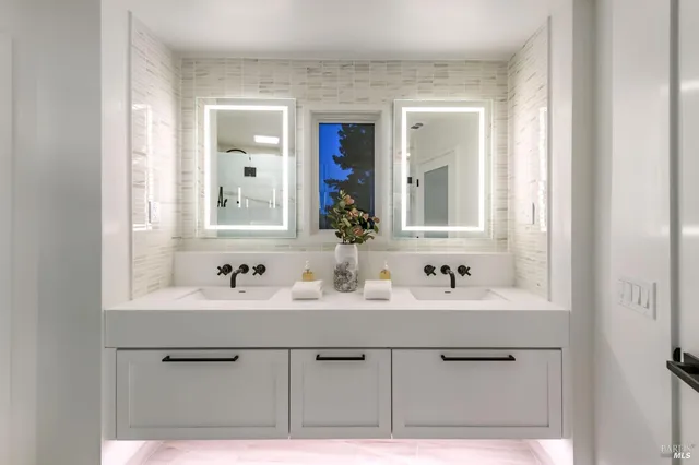 a bathroom with a sink vanity and mirror