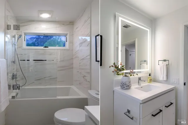 a bathroom with a sink a toilet and shower