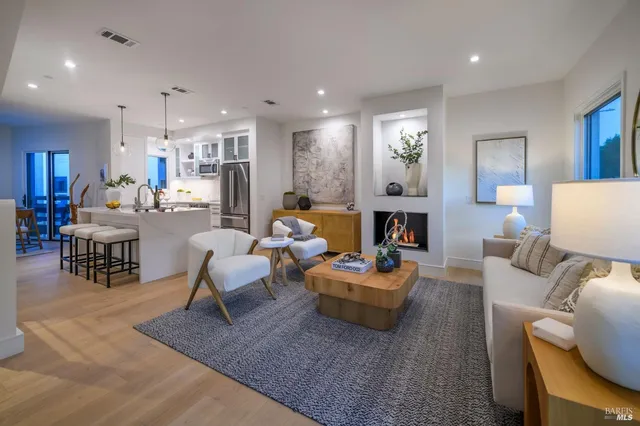 a living room with fireplace furniture and a wooden floor