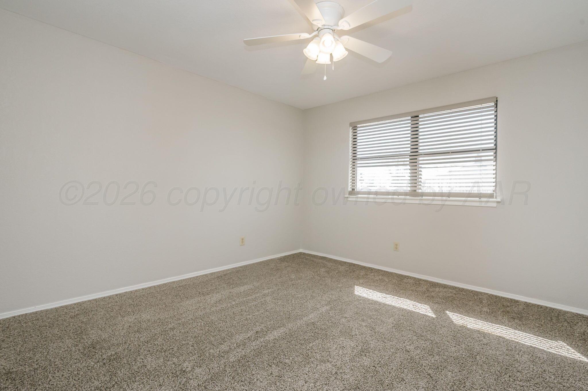 6000 Hampton Drive Amarillo, TX 79109 - Photo 16 of 19 an empty room with a window and a fan