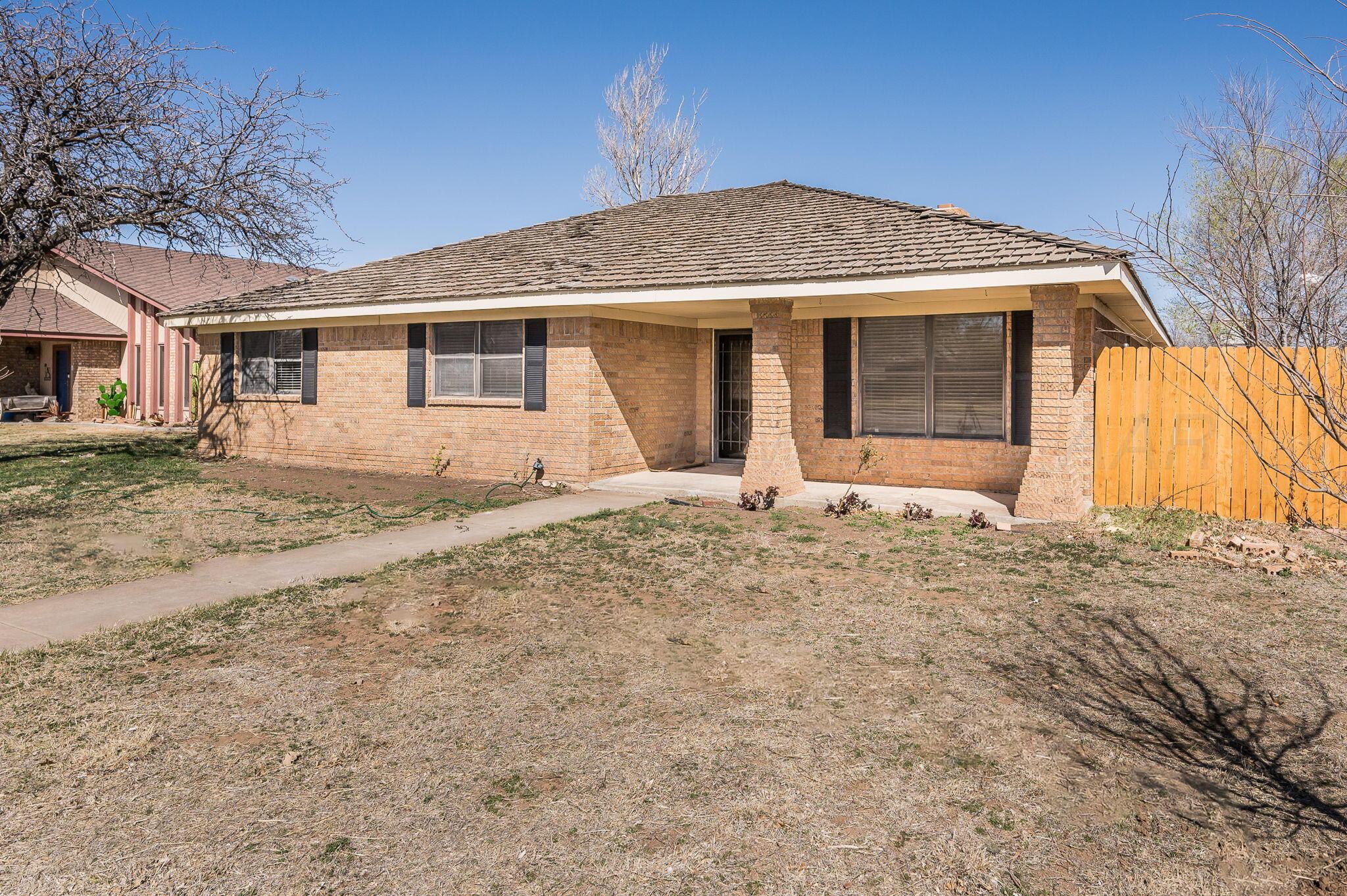 6000 Hampton Drive Amarillo, TX 79109 - Photo 19 of 19 a front view of a house with a yard